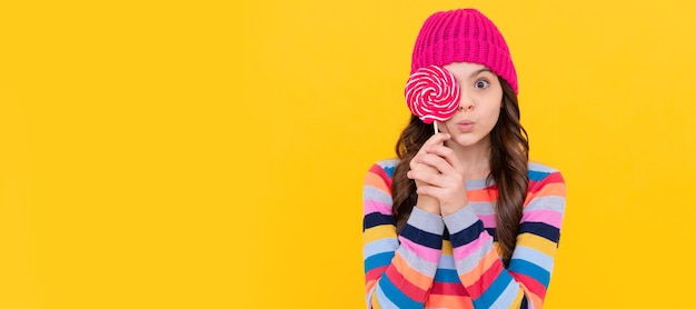 Photo surprised teen girl hold lollipop lollipop lady hipster kid with colorful lollypop sugar candy teenager child with sweets poster banner header copy space