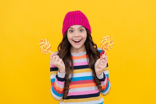 Surprised teen girl with lollipop candy happiness