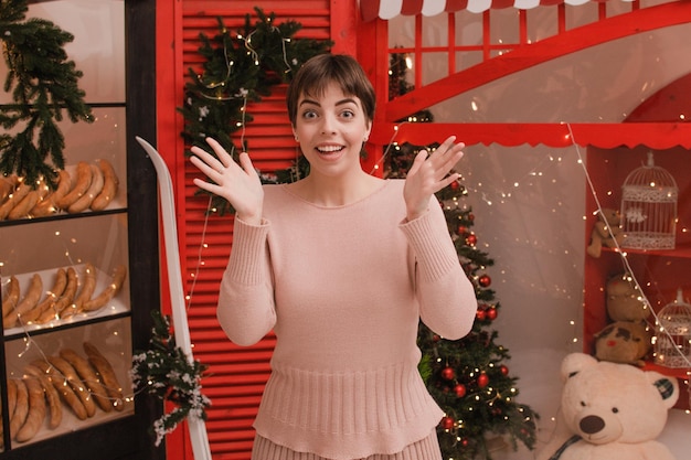 Surprised woman on the background of the Christmas showcase