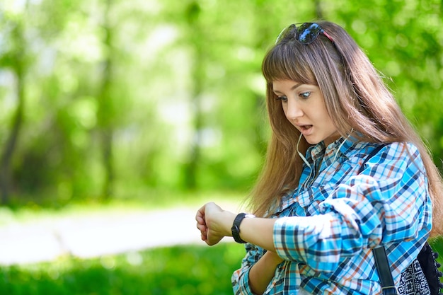 Surprised woman looking at her watch with funny face expression late for meeting Human face expression emotions feelings