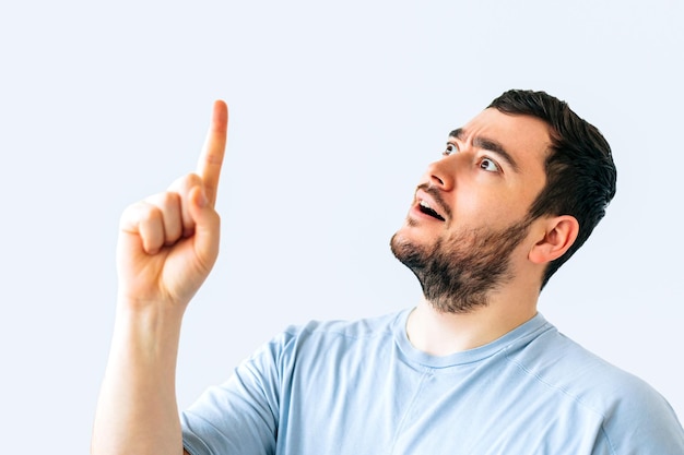 Surprised young bearded handsome man wearing yellow hat cap standing over isolated white background