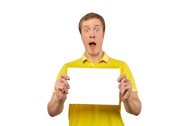 Surprised young man holding blank paper sheet paper mockup isolated on white background