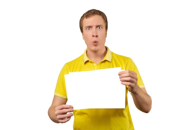 Surprised young man holding blank paper sheet paper mockup isolated on white background