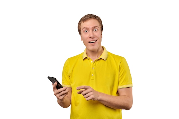 Surprised young man with smartphone funny guy holding phone isolated on white background