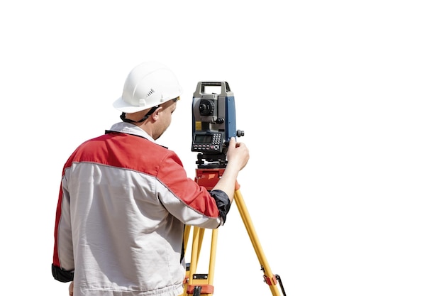 Surveyor engineer measures the level on a white isolated background Surveyors provide accurate measurements before embarking on large construction projects