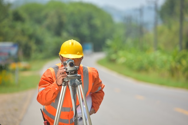 Surveyor engineer worker making measuring with theodolite on road works.survey engineer in construction site.