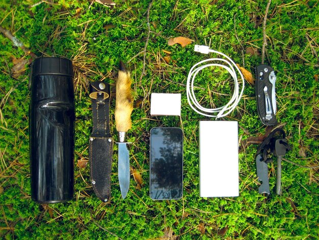 Photo survival set of a forester knife bottle powerbank phone fire