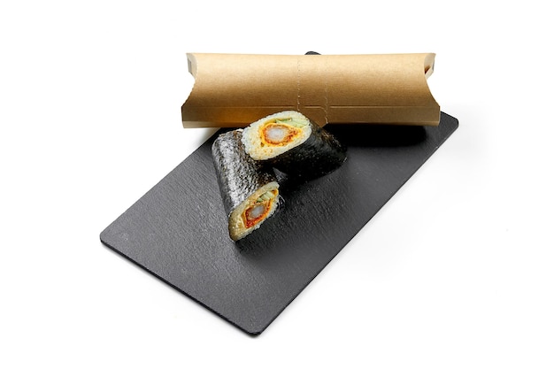 Sushi burrito with shrimp in nori on black board Closeup selective focus White background