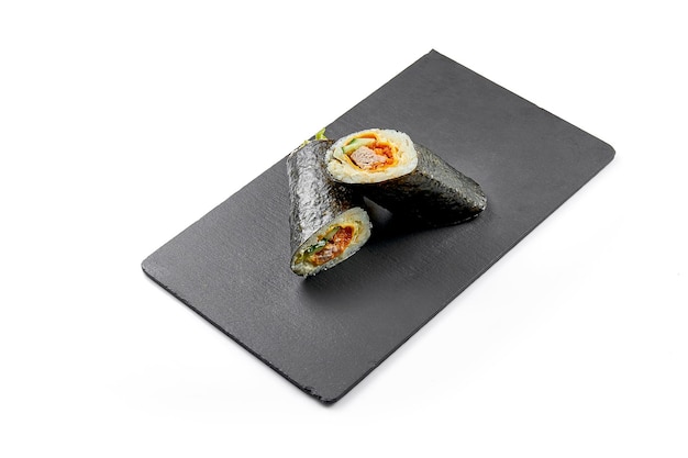 Sushi burrito with tuna in nori on black board Closeup selective focus White background