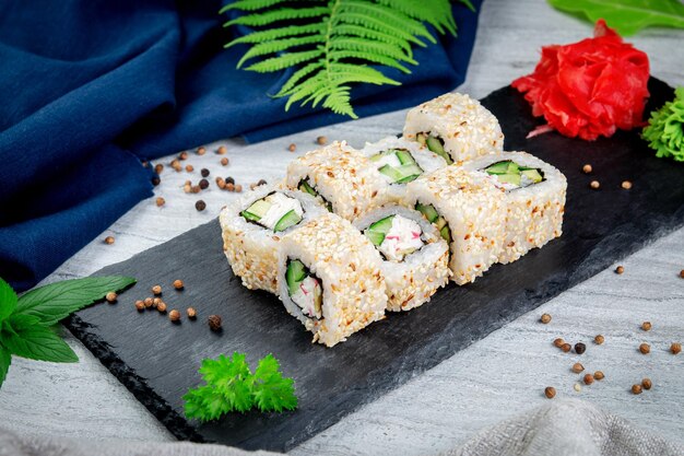 Sushi California rolls with sesame and avocado crab sauce and cucumber Traditional Japanese cuisine