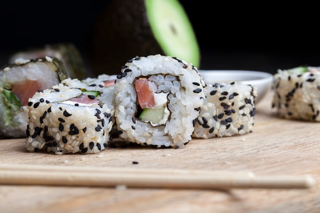 Sushi made from white rice, trout and avocado, ready-to-eat vegetable products and red fish salmon