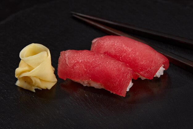 Sushi nigiri with tuna on black background