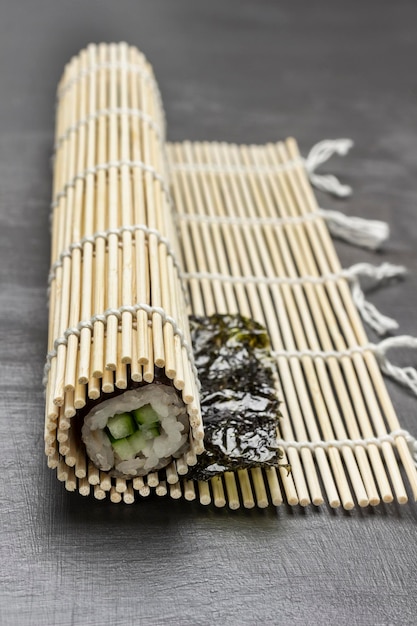 Sushi nori with cucumber on a bamboo mat