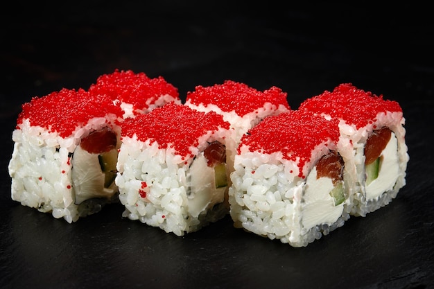 Sushi Philadelphia roll with fresh salmon cucumber avocado cream cheese tobiko red caviar