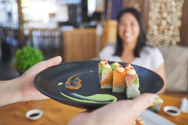 Sushi restaurant people and waiter hands serving food plate order or fish product for diner cafeteria or shop customer Startup small business server and closeup person with lunch meal for client