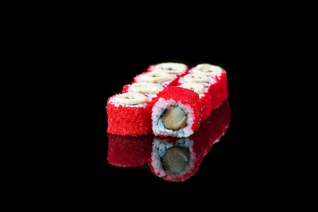 Sushi roll on a black background reflection  japanese food close up