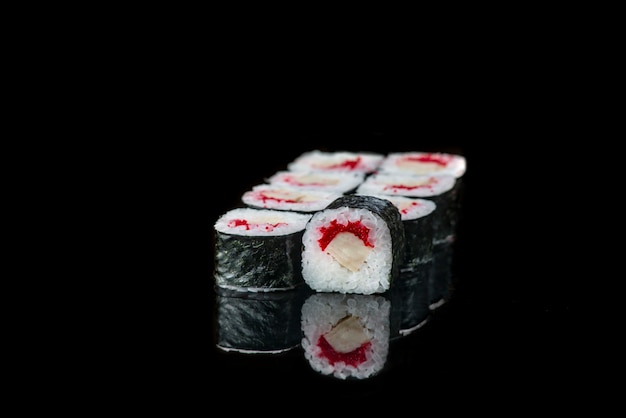 Sushi Roll On A Black wall reflection . Japanese food. Close Up.