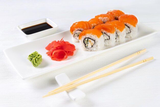 Sushi roll Philadelphia with salmon smoked eel avocado cream cheese on white background