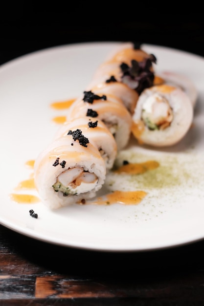 Sushi roll set on white plate with caviar