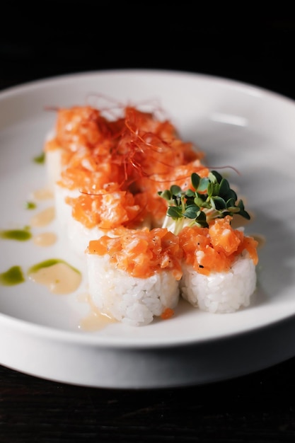 Sushi roll set on white plate with salmon