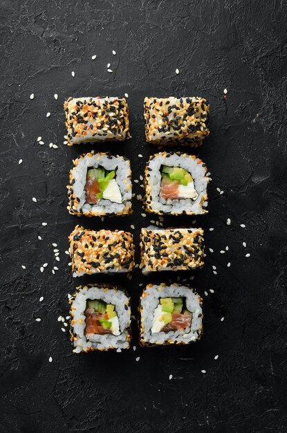 Sushi roll with sesame Philadelphia cheese salmon avocado Japanese Traditional Cuisine Top view Rustic style