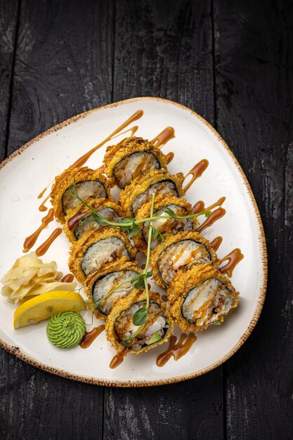 sushi roll with wasabi and sesame seeds on the plate. delicious food, close-up