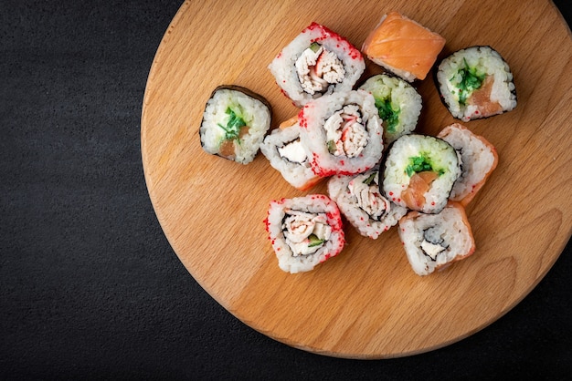 Sushi rolls on black background. Japanese food.