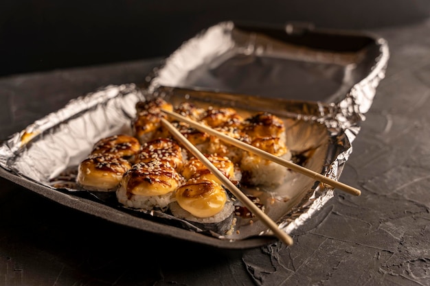 Sushi rolls in a plastic thermo container Takeaway food