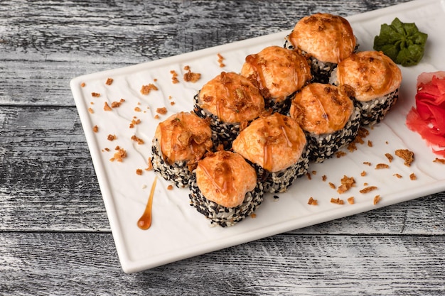 Sushi rolls sushi with fish on a white wooden background