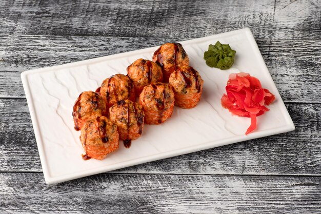 Sushi rolls sushi with fish on a white wooden background