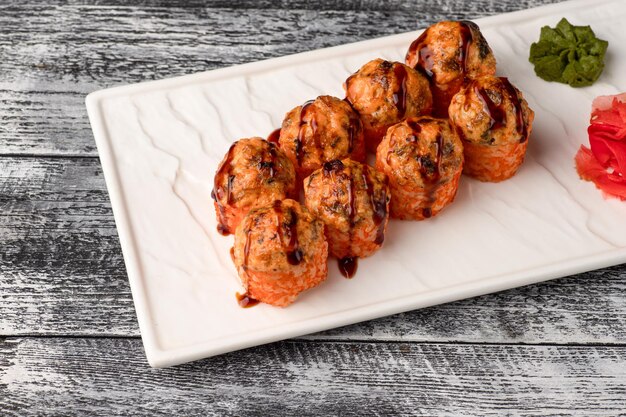 Sushi rolls sushi with fish on a white wooden background