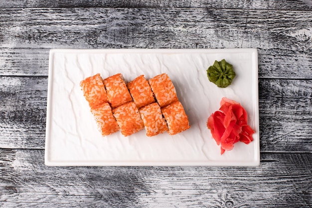 Sushi rolls sushi with fish on a white wooden background