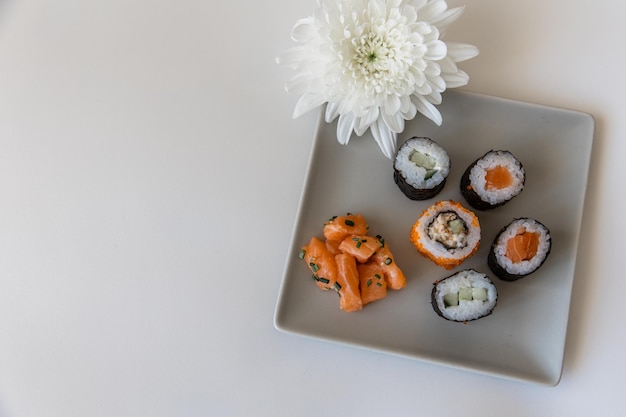 Sushi and rolls on a terrace on a white background closeup