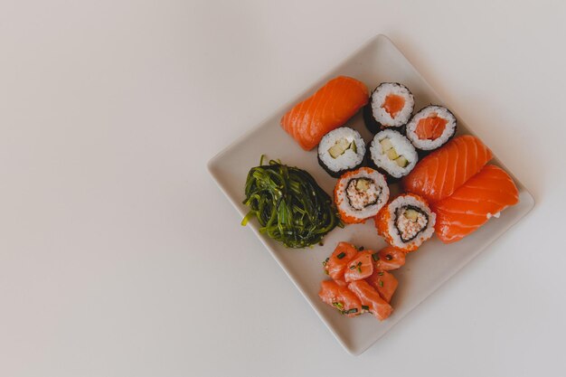 Sushi and rolls on a terrace on a white background closeup