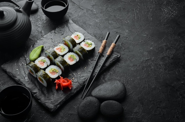 Sushi rolls with avocado and salmon Classic Japanese sushi Top view Free space for your text