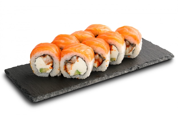 Sushi Rolls with eel, salmon, avocado, flying fish caviar and Cream Cheese inside isolated on white