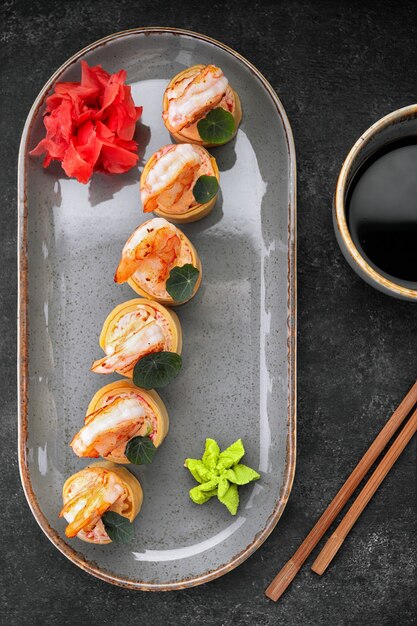 Photo sushi rolls with omelet shrimps and crab sticks