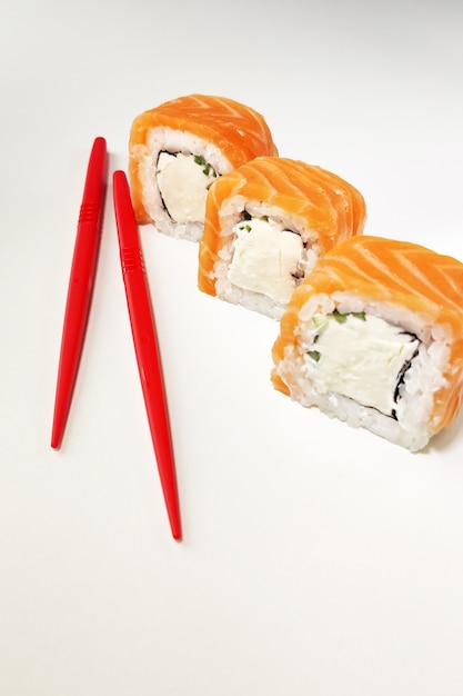 sushi rolls with salmon and chopsticks