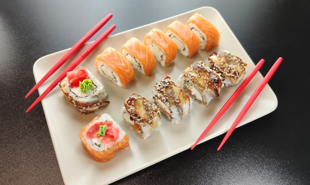 sushi rolls with salmon and chopsticks