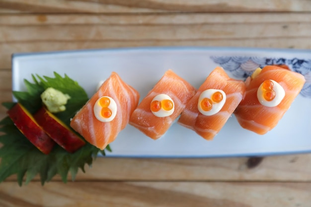 Sushi rolls with salmon on top , Japanese cuisine on top view