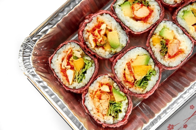 Sushi rolls with shrimp and avocado in a plate on a white background Closeup Selective focus