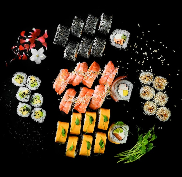 Sushi set on black background top view Assortment of fresh mouthwatering sushi in an oriental restaurant