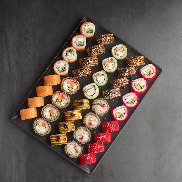 Sushi set Roll with fresh ingredients on stone background Top view