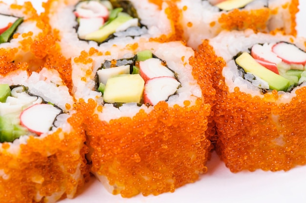 Sushi set with crab meat, avocado and red caviar on white background