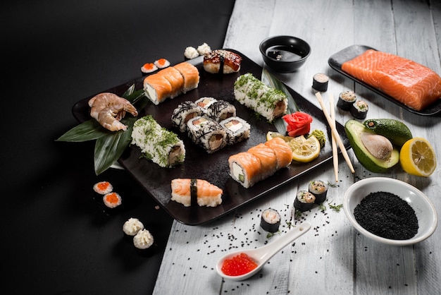 Sushi set with salmon eel tuna avocado cream cheese Philadelphia caviar chuka Sushi menu Japanese food on black and white background