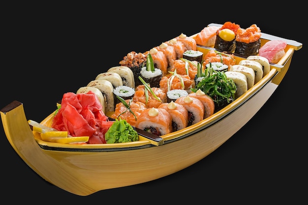 Sushi set in a wooden boat on a black background