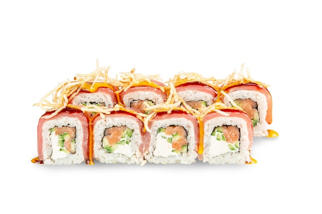 Sushi tsunami roll with tuna and salmon cucumber and cream cheese topping sprinkled with pai potatoes drizzled with mango and kabayaki sauce on a white isolated background