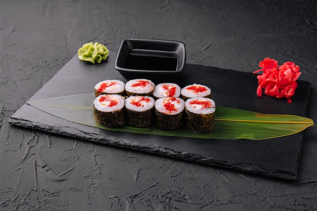 Sushi with red caviar on black stone