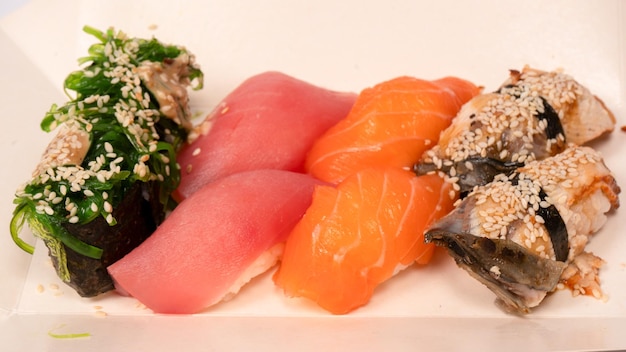 Sushi with salmon eel tuna hiyashi wakame sesame isolated on a white background