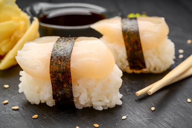 Sushi with scallop on a black